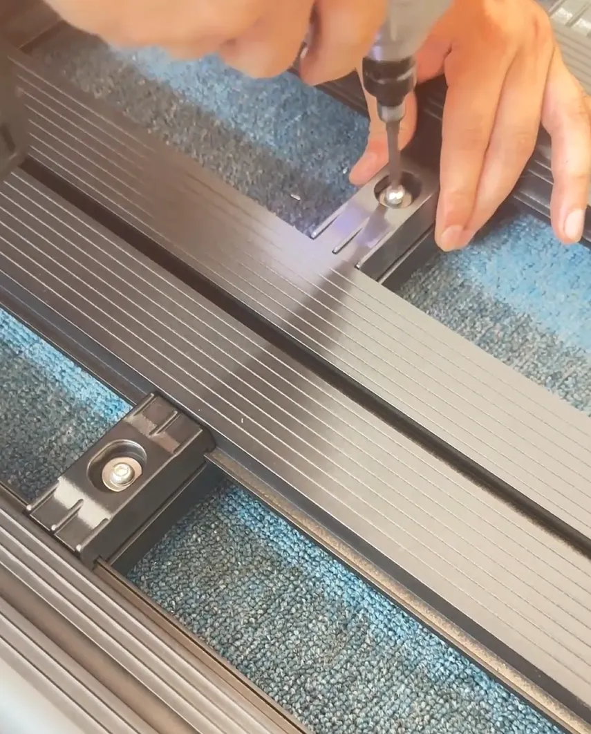 Power drill assembling Audi Q5 roof rack platform